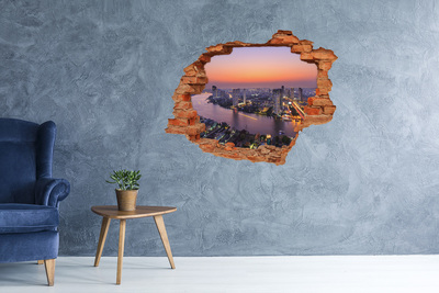 Hole wall sticker View of the city at sunset