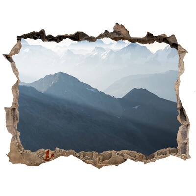 Hole wall sticker Mountain landscape through a hole in the wall