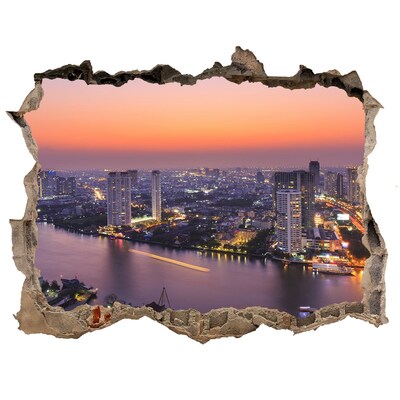 Hole wall sticker View of the city at sunset
