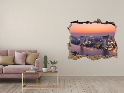Hole wall sticker View of the city at sunset