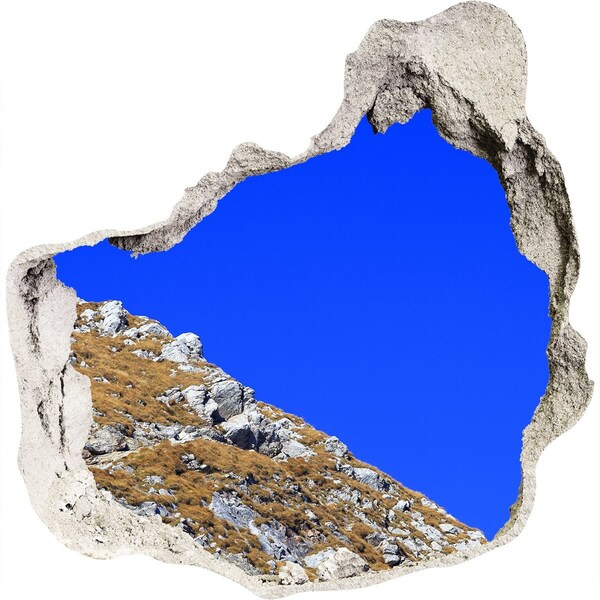 Hole in the wall sticker Mountain landscape through a hole in the wall