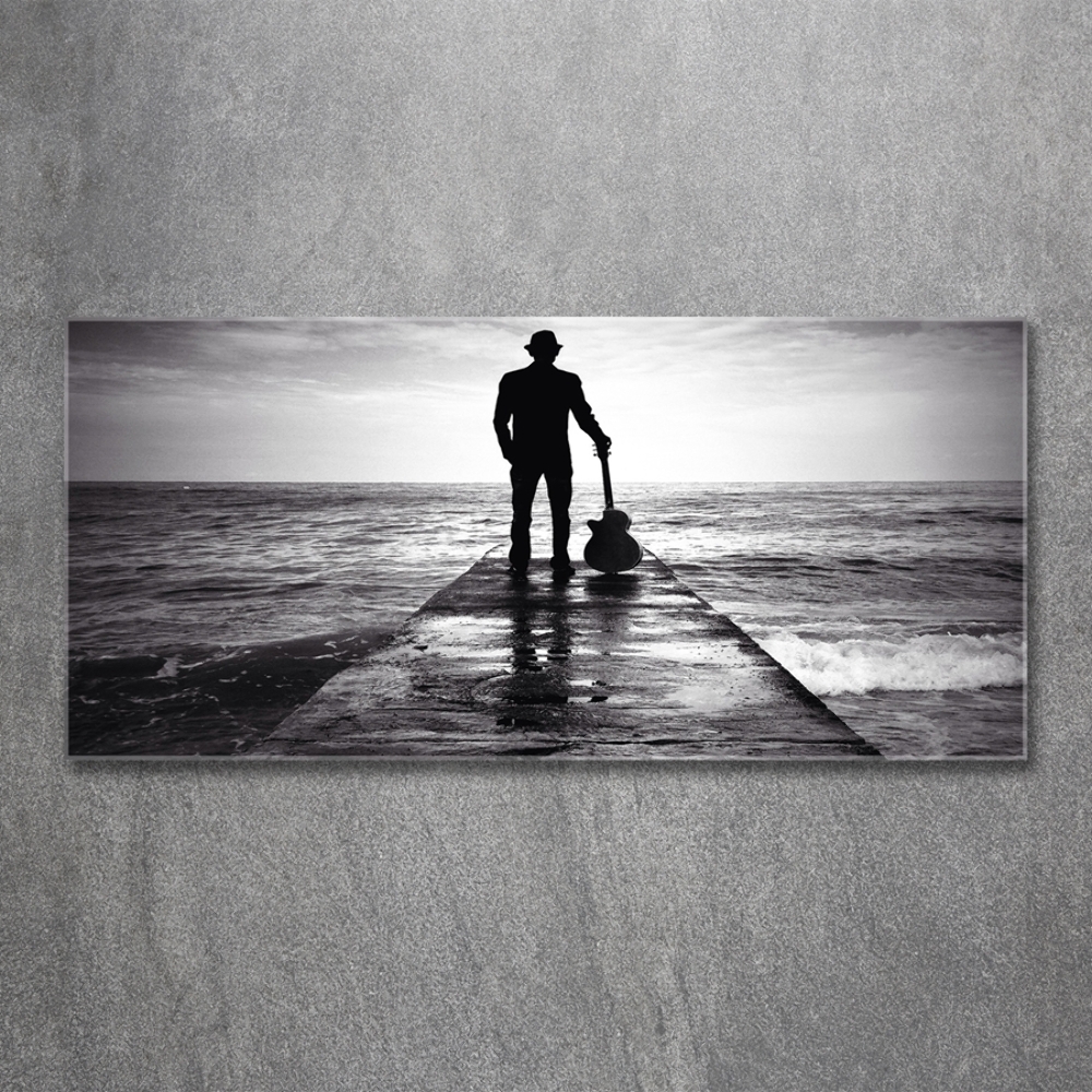 Photo printed on glass Guitarist on the pier