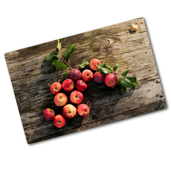 Chopping board glass Apples on the table