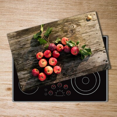 Chopping board glass Apples on the table