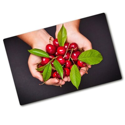 Chopping board glass Cherries in the hands