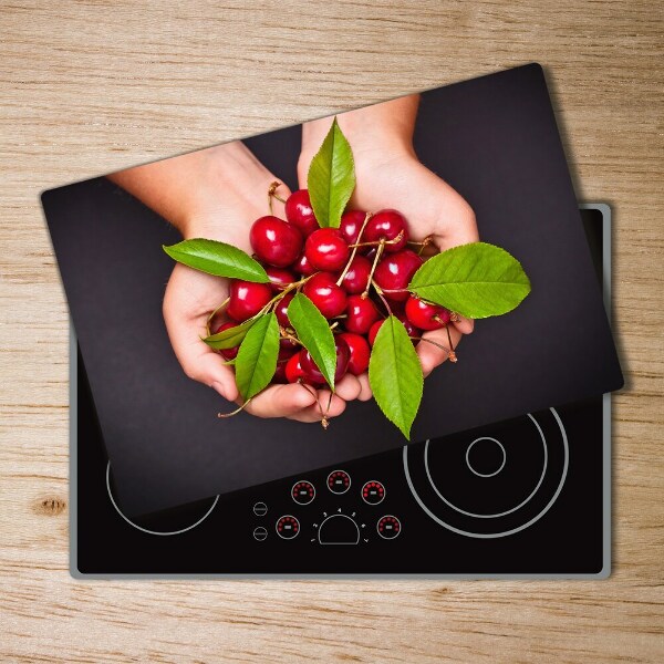 Chopping board glass Cherries in the hands