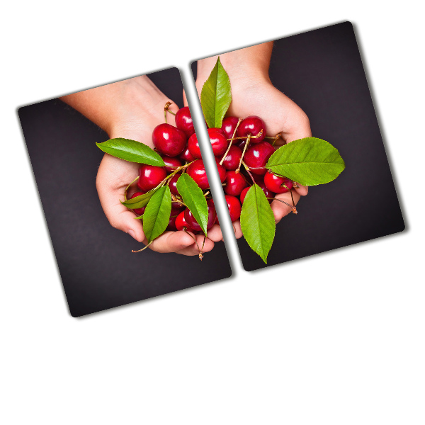 Chopping board glass Cherries in the hands