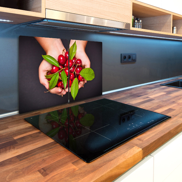 Chopping board glass Cherries in the hands