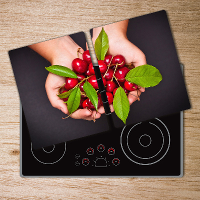 Chopping board glass Cherries in the hands