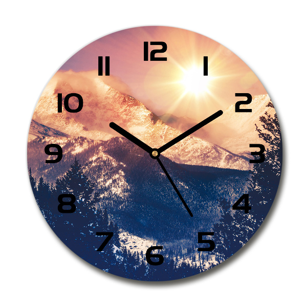 Round wall clock The sun over the mountains