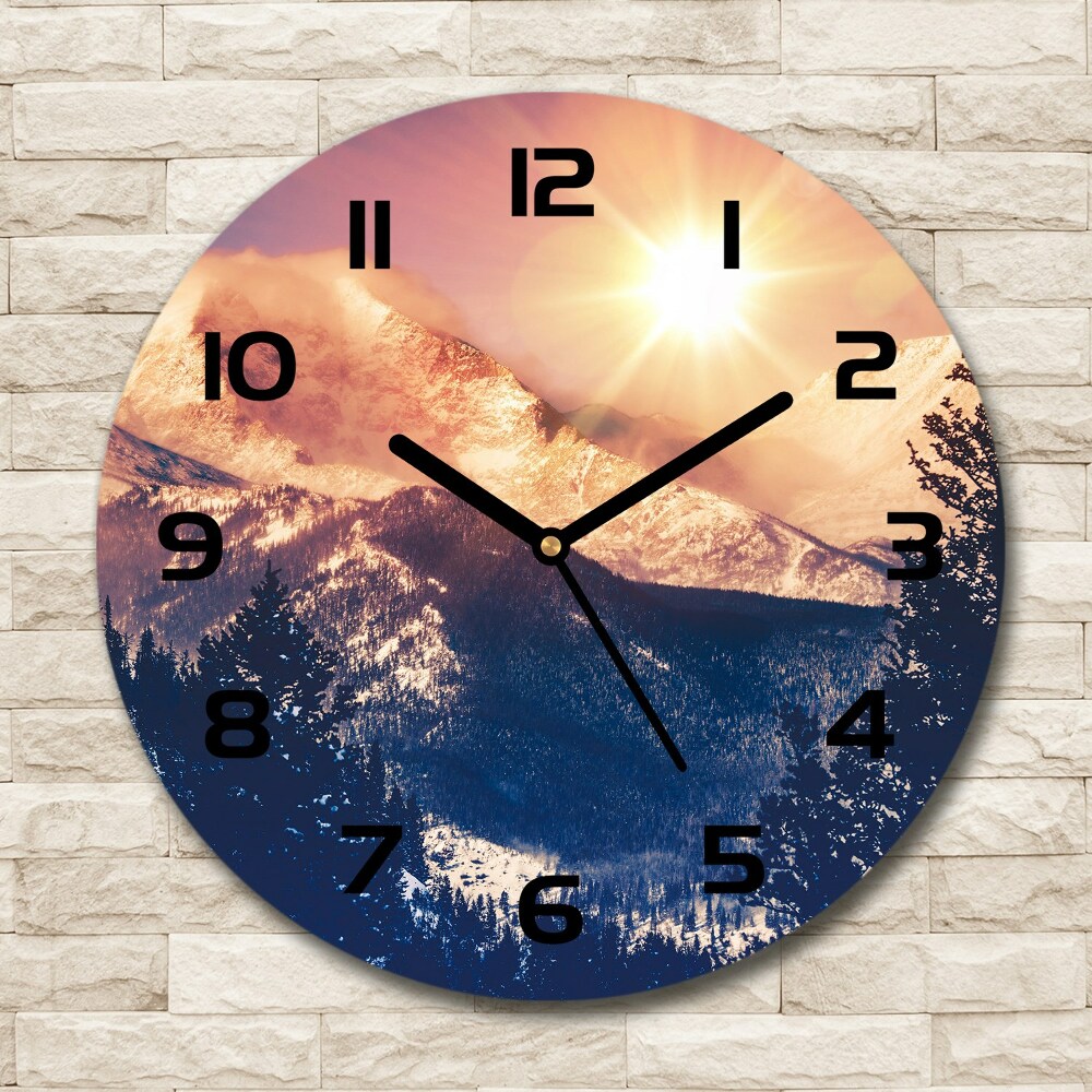 Round wall clock The sun over the mountains