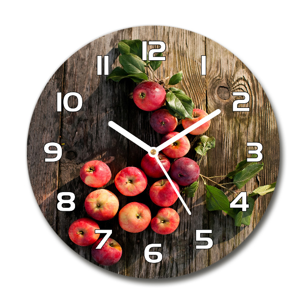 Round glass clock Apples on the table