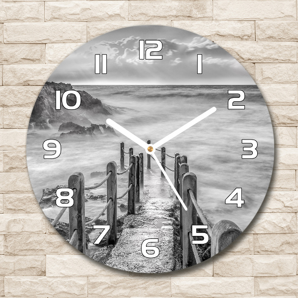 Round glass wall clock Path at the sea