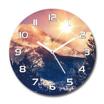 Round wall clock The sun over the mountains