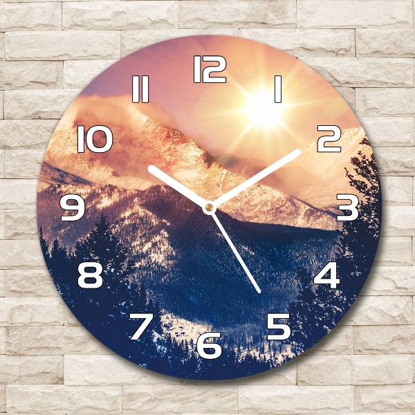 Round wall clock The sun over the mountains