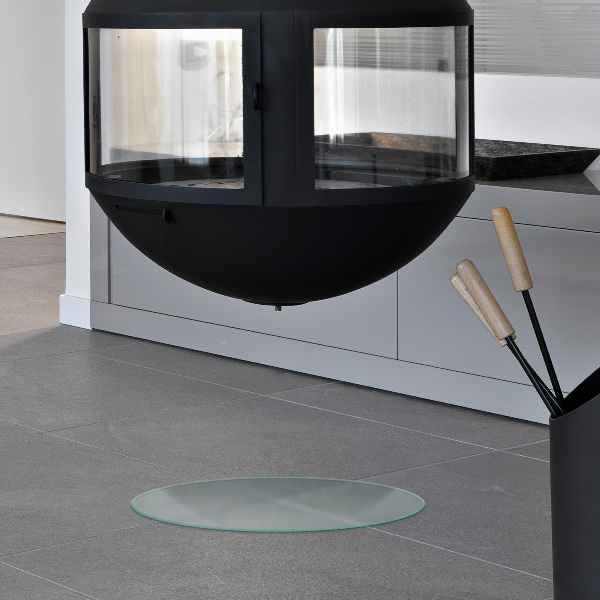 Round wood burner hearth pad with a milky glass optical effect