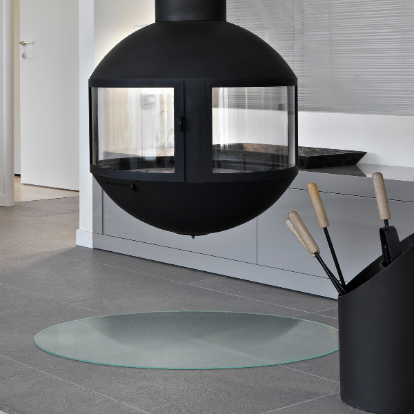 Round wood burner hearth pad with a milky glass optical effect
