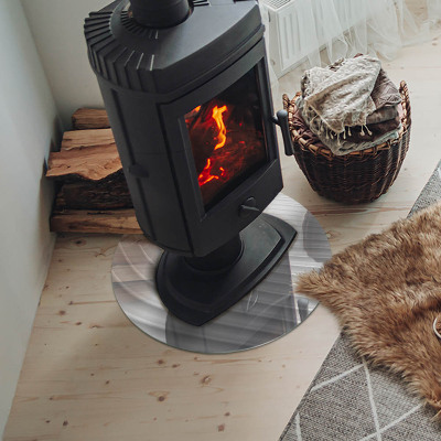 Round glass hearth for log burner Waves of subtle shapes