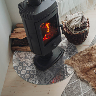 Round glass hearth for log burner Arrangement of mosaic decorations