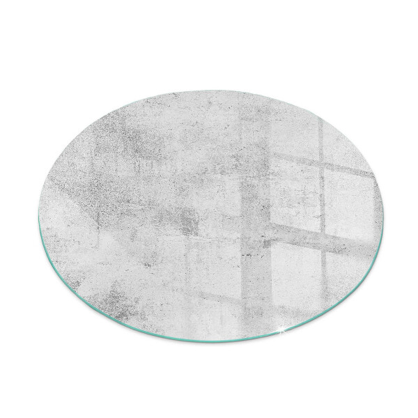 Round glass hearth for log burner Concrete texture in a raw style