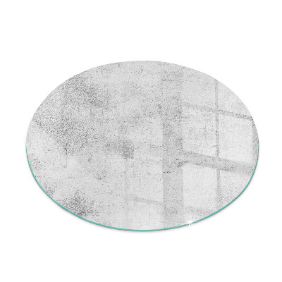 Round glass hearth for log burner Concrete texture in a raw style