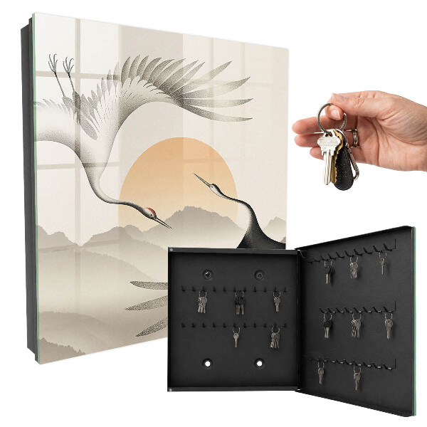 Key box Japanese cranes against the backdrop of the rising sun