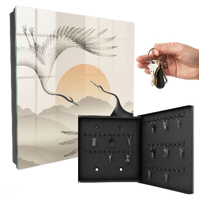 Key box Japanese cranes against the backdrop of the rising sun