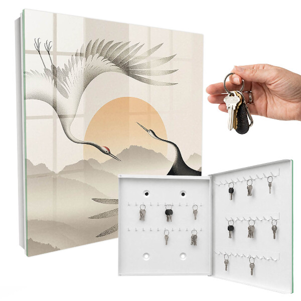Key box Japanese cranes against the backdrop of the rising sun