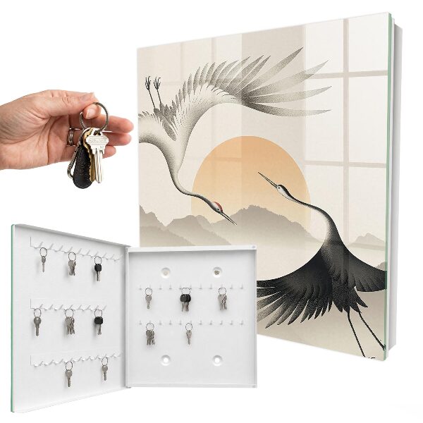 Key box Japanese cranes against the backdrop of the rising sun