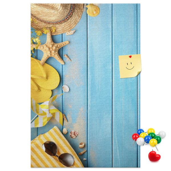 Cork notice board Summer accessories against a blue wooden background
