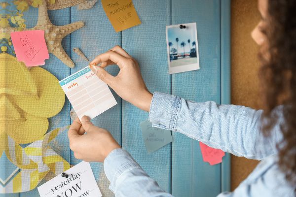 Cork notice board Summer accessories against a blue wooden background