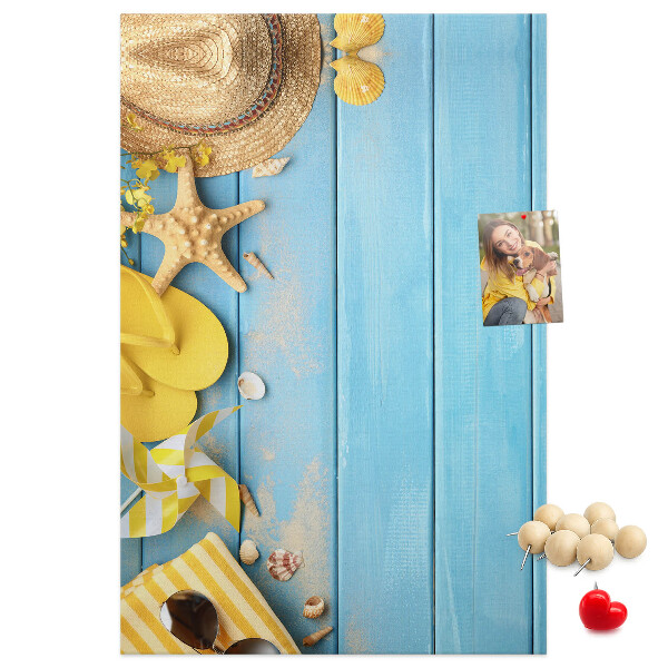Cork notice board Summer accessories against a blue wooden background