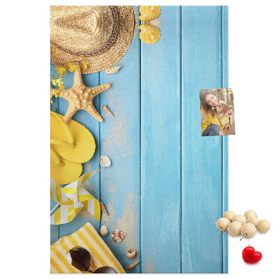 Cork notice board Summer accessories against a blue wooden background