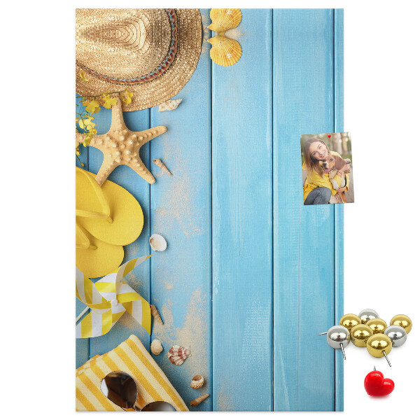Cork notice board Summer accessories against a blue wooden background