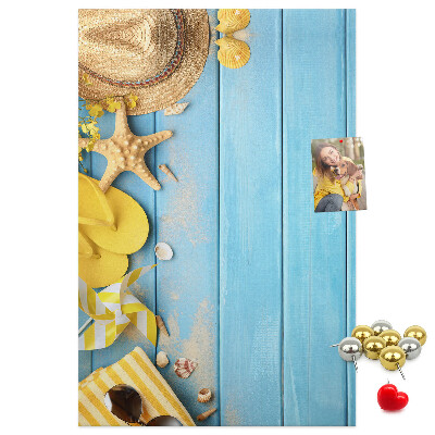 Cork notice board Summer accessories against a blue wooden background