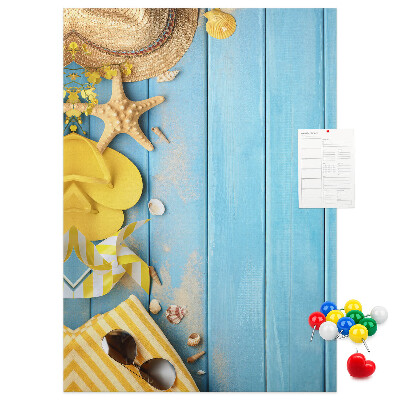 Cork notice board Summer accessories against a blue wooden background