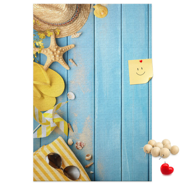 Cork notice board Summer accessories against a blue wooden background