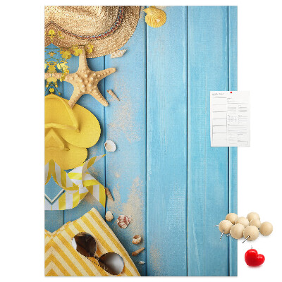Cork notice board Summer accessories against a blue wooden background