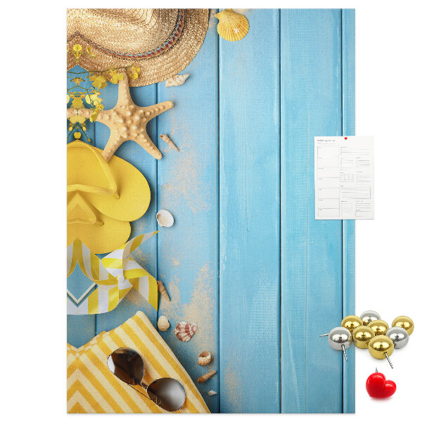 Cork notice board Summer accessories against a blue wooden background