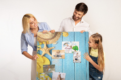 Cork notice board Summer accessories against a blue wooden background