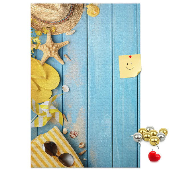 Cork notice board Summer accessories against a blue wooden background