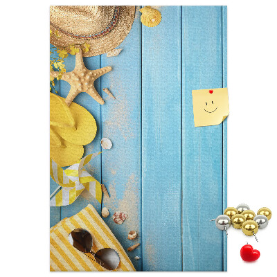 Cork notice board Summer accessories against a blue wooden background