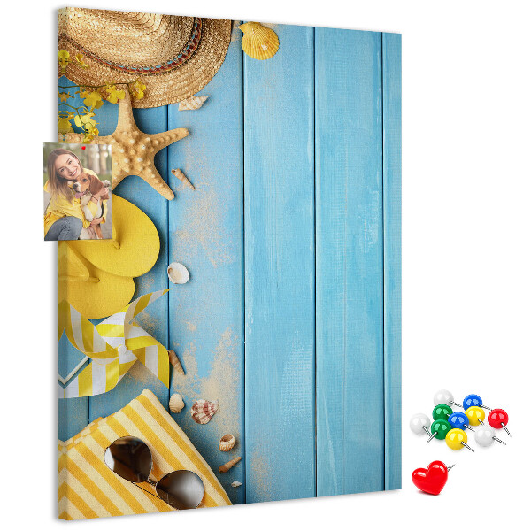 Cork notice board Summer accessories against a blue wooden background