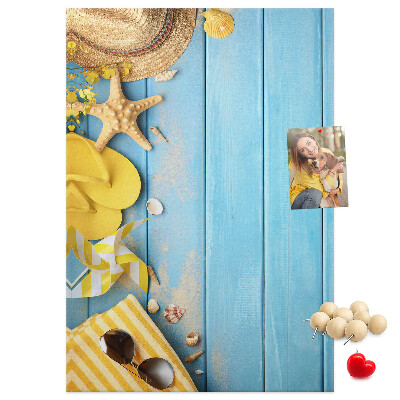 Cork notice board Summer accessories against a blue wooden background
