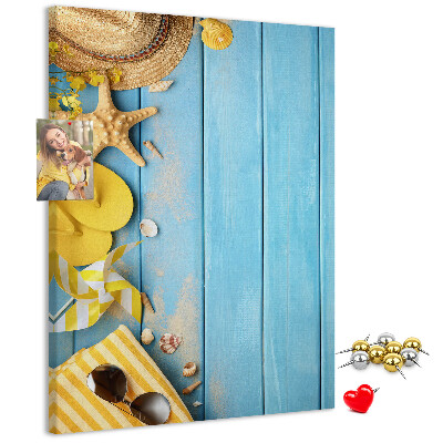 Cork notice board Summer accessories against a blue wooden background