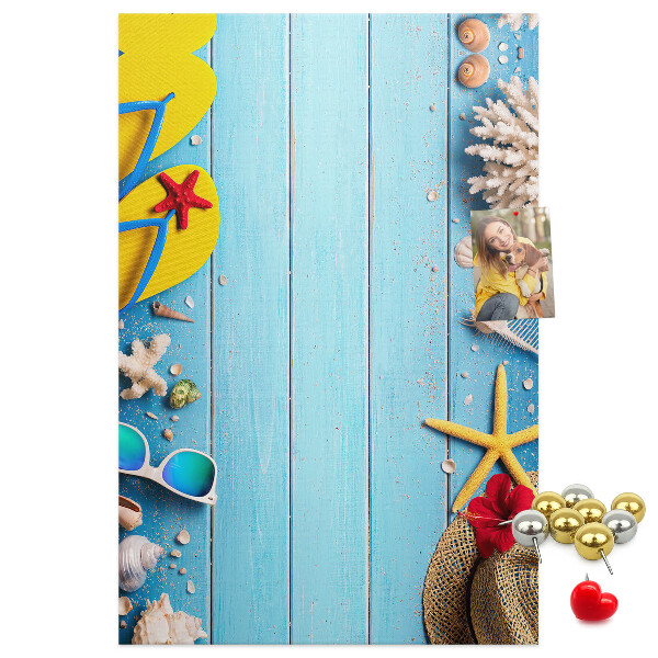 Wall cork memo board Summer accessories on a blue wood background