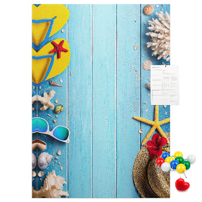 Wall cork memo board Summer accessories on a blue wood background