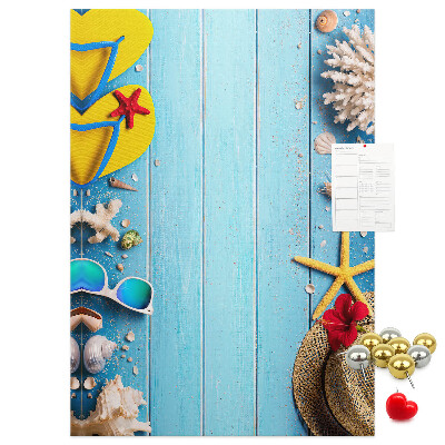 Wall cork memo board Summer accessories on a blue wood background