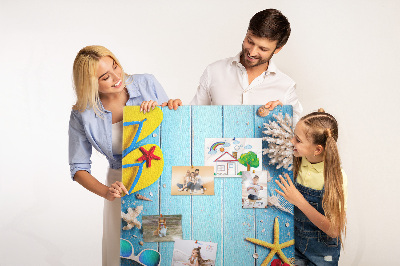 Wall cork memo board Summer accessories on a blue wood background