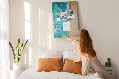 Memo cork board A beach with waves and people walking around